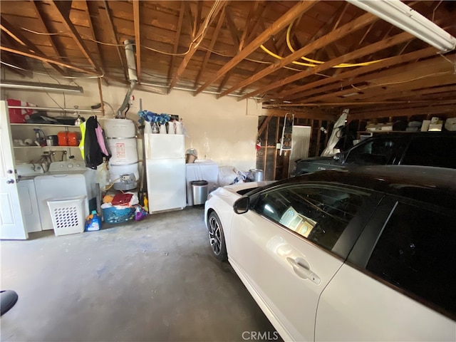 garage featuring white refrigerator and washing machine and dryer