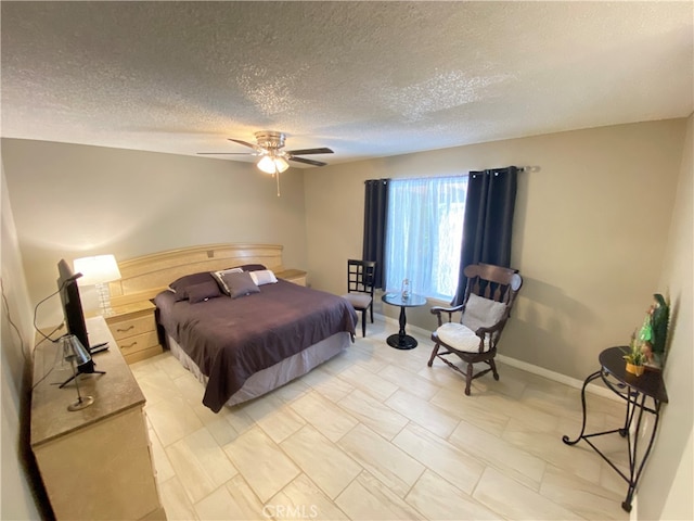 bedroom featuring a textured ceiling and ceiling fan