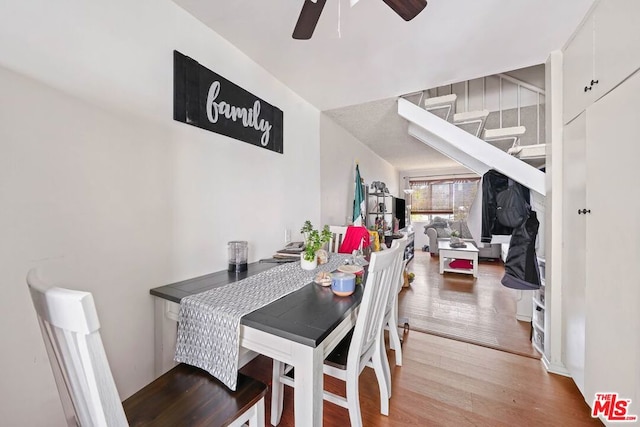 dining space with light hardwood / wood-style floors and ceiling fan