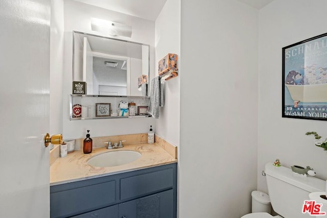 bathroom with vanity and toilet