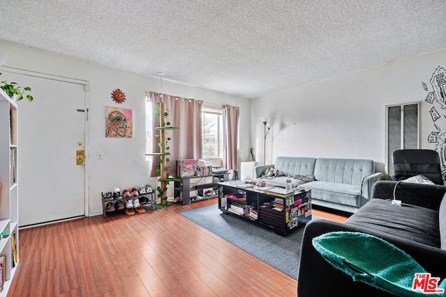 living room featuring hardwood / wood-style flooring and a textured ceiling