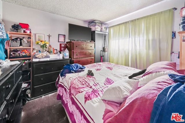 carpeted bedroom featuring a textured ceiling