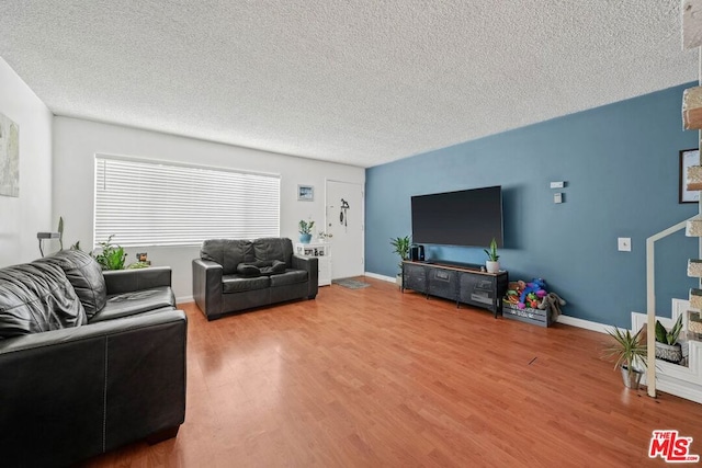 living room featuring a textured ceiling and hardwood / wood-style floors