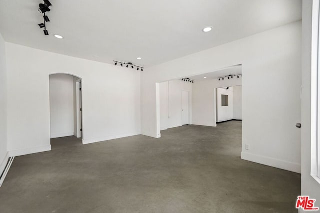 unfurnished room with concrete flooring