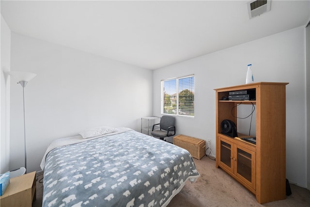 bedroom featuring light carpet and radiator heating unit