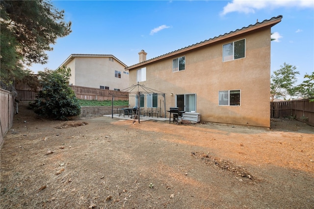 back of property featuring a patio