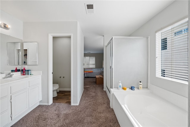 full bathroom featuring separate shower and tub, vanity, and toilet