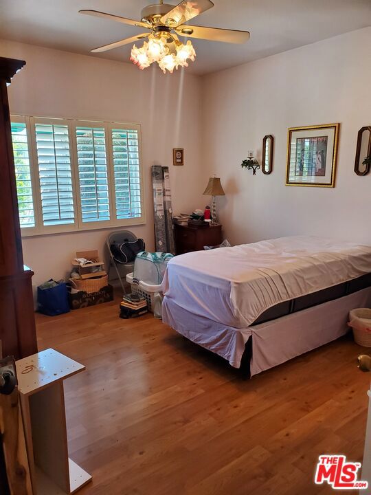 bedroom featuring hardwood / wood-style flooring and ceiling fan