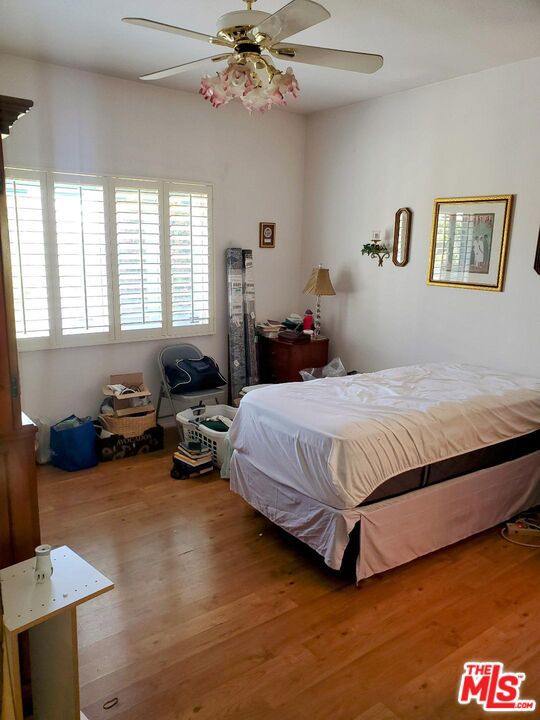 bedroom featuring hardwood / wood-style flooring and ceiling fan