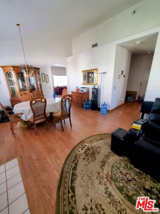 living room with hardwood / wood-style flooring and an inviting chandelier