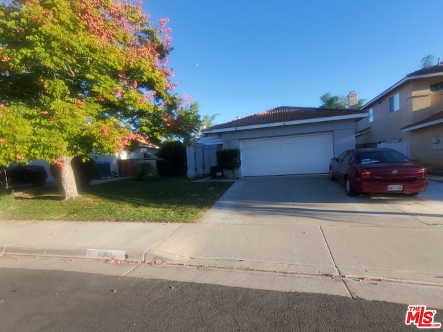 view of front facade with a garage and a front lawn