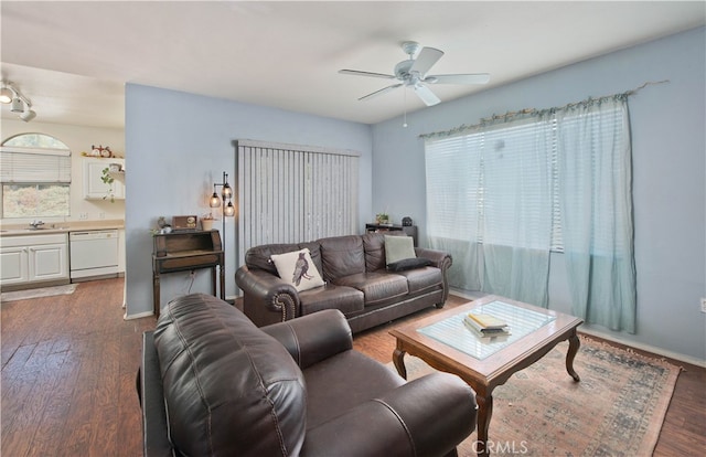 living room featuring dark wood-type flooring, ceiling fan, and sink