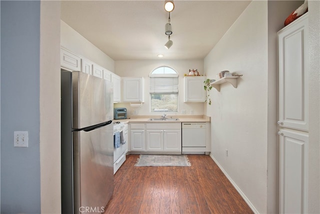 kitchen with white appliances, white cabinetry, sink, and dark wood-type flooring