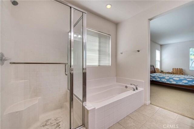 bathroom with separate shower and tub, tile patterned floors, and a healthy amount of sunlight