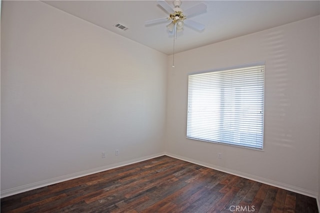 empty room featuring dark hardwood / wood-style flooring and ceiling fan