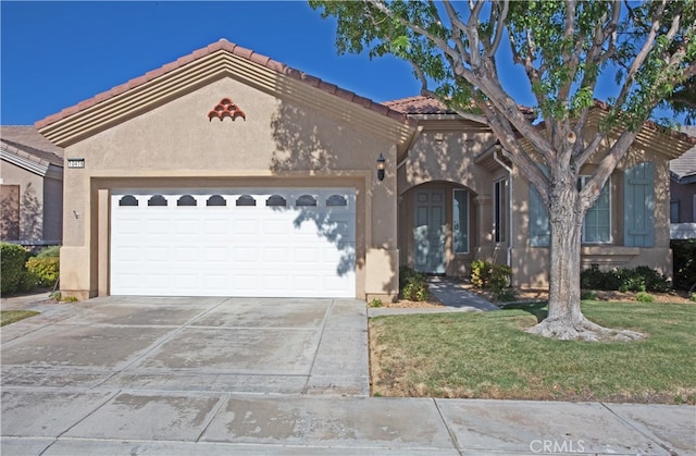 view of front of property featuring a garage and a front yard