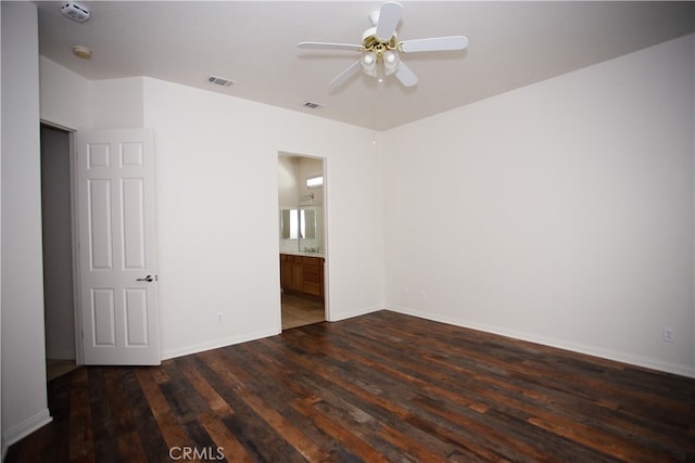 empty room with ceiling fan and dark wood-type flooring