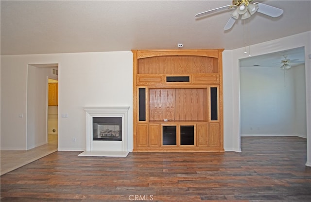 interior space with ceiling fan and dark hardwood / wood-style floors