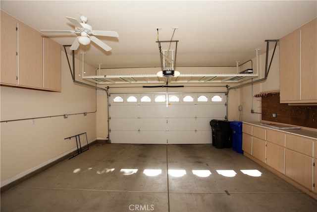 garage featuring a garage door opener and ceiling fan