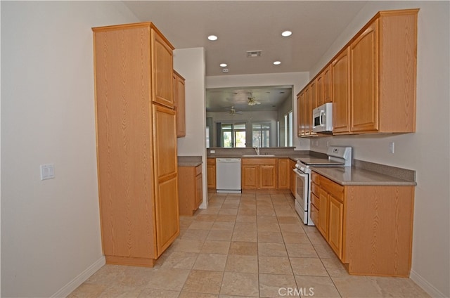 kitchen featuring light tile patterned floors, white appliances, sink, and ceiling fan