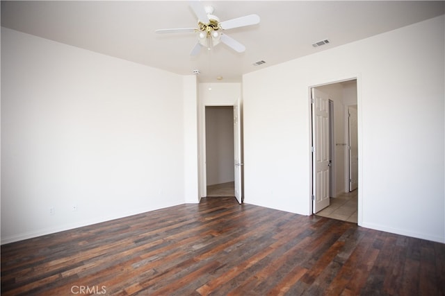 empty room featuring ceiling fan and dark wood-type flooring