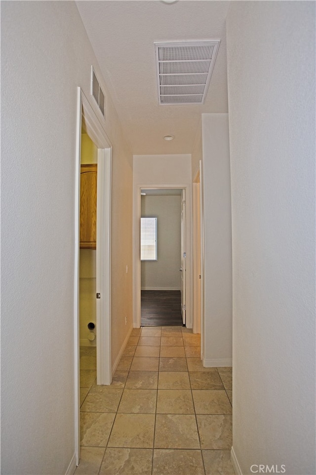 hallway featuring light tile patterned floors