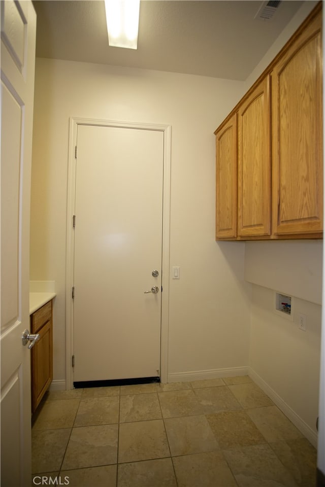 clothes washing area with hookup for a washing machine and cabinets