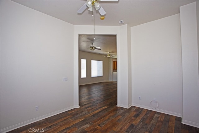 unfurnished room with ceiling fan and dark hardwood / wood-style flooring