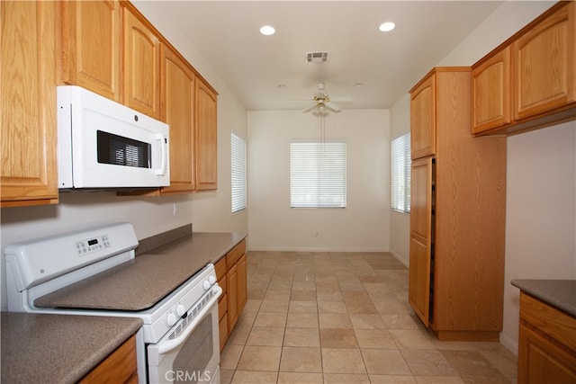 kitchen with ceiling fan, light tile patterned floors, and white appliances