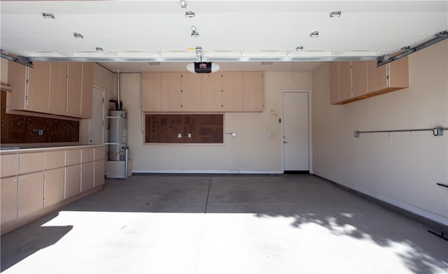 garage with strapped water heater and a garage door opener