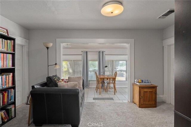 living room featuring light colored carpet and plenty of natural light