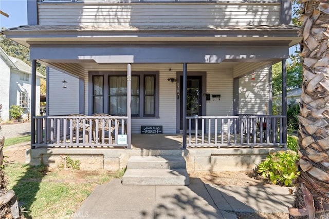 view of exterior entry with covered porch