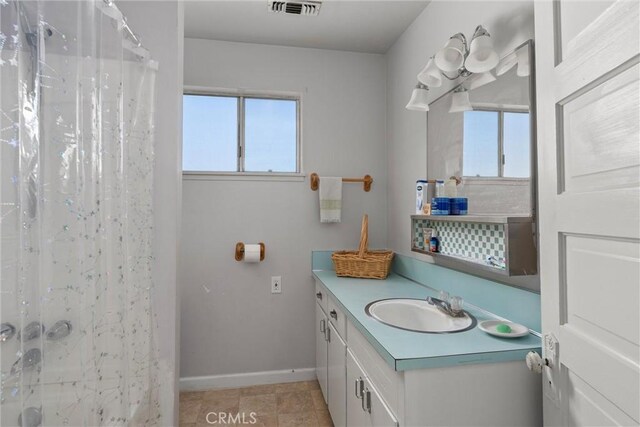 bathroom featuring vanity and curtained shower