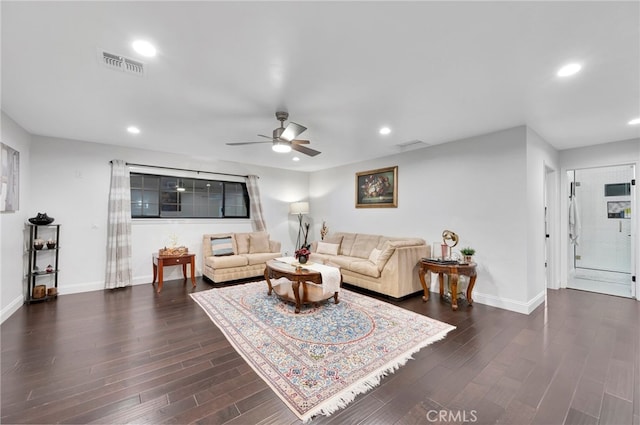 living room featuring dark hardwood / wood-style flooring and ceiling fan