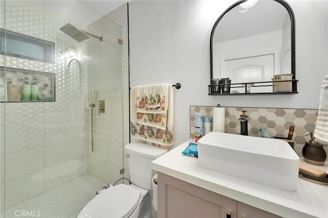 bathroom featuring walk in shower, vanity, tile walls, and toilet