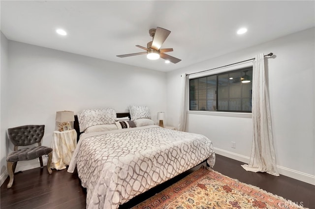 bedroom with dark hardwood / wood-style floors and ceiling fan