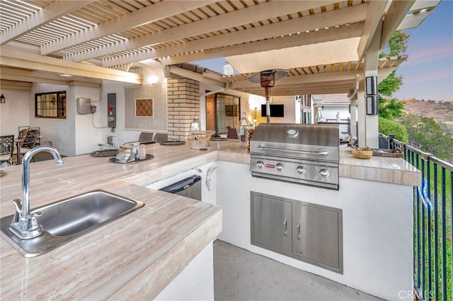 view of patio with area for grilling, sink, a grill, and a pergola