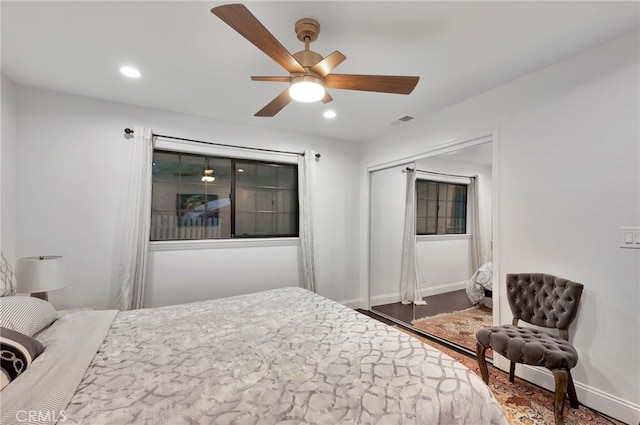 bedroom with ceiling fan, a closet, and dark hardwood / wood-style floors