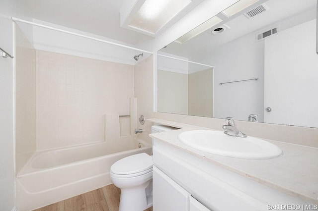 full bathroom featuring toilet, vanity, shower / washtub combination, and hardwood / wood-style floors