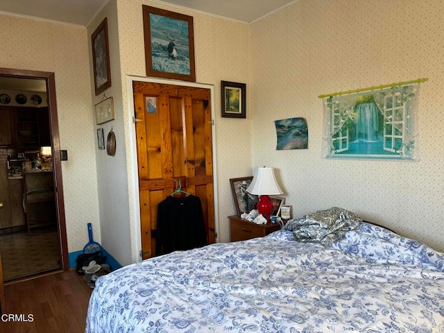 bedroom featuring hardwood / wood-style flooring and crown molding