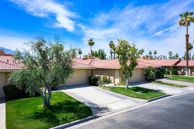 view of front of property featuring a garage and a front lawn