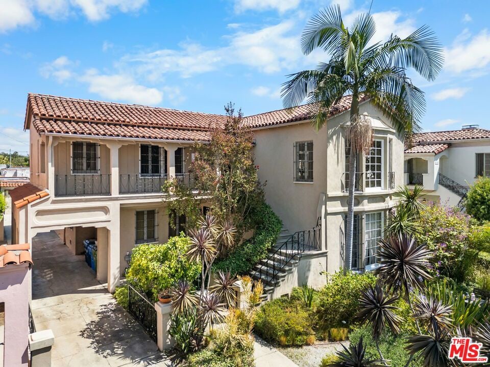 mediterranean / spanish house featuring a balcony and a garage