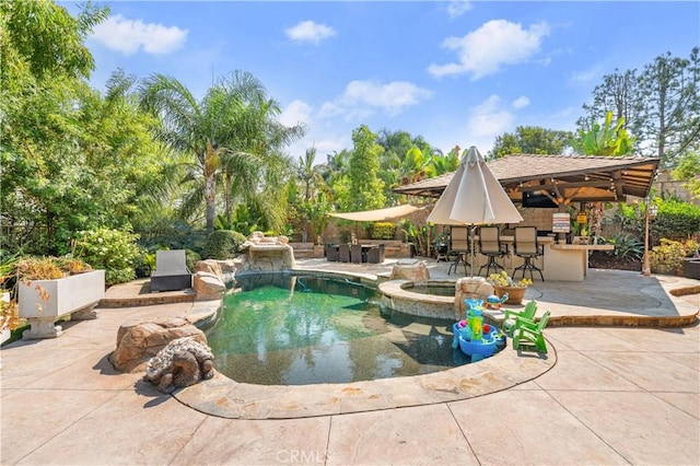 view of swimming pool with an outdoor bar and a patio area