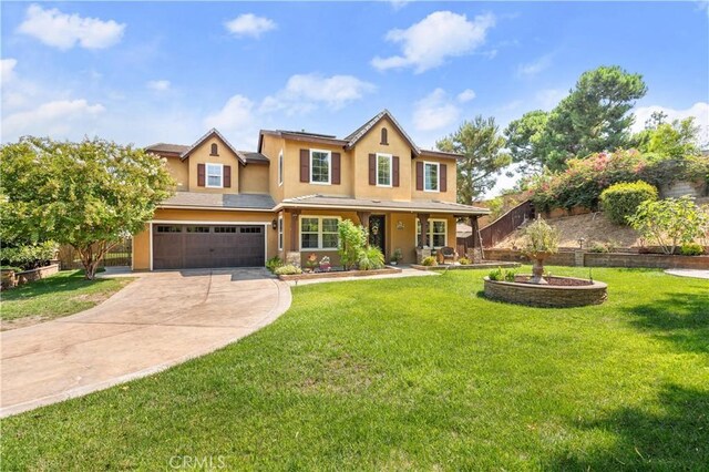 view of front of home featuring a garage and a front yard