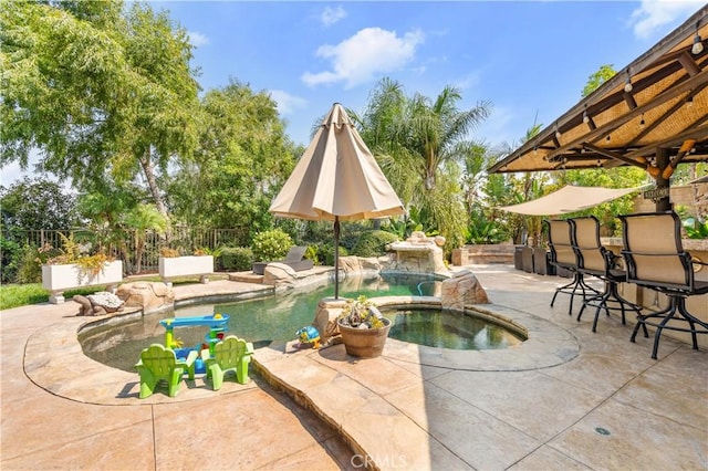 view of swimming pool with an in ground hot tub and a patio