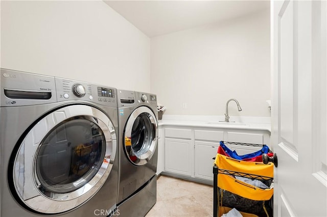 laundry area featuring cabinets, sink, washer and dryer, and light tile patterned floors