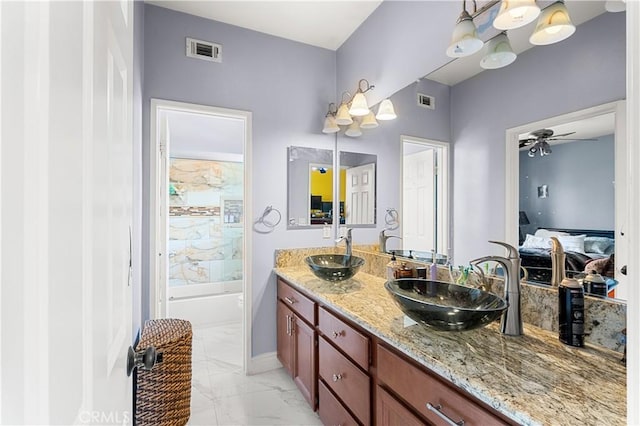 bathroom featuring ceiling fan and vanity