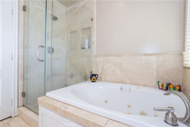 bathroom with tile walls, tile patterned flooring, and independent shower and bath