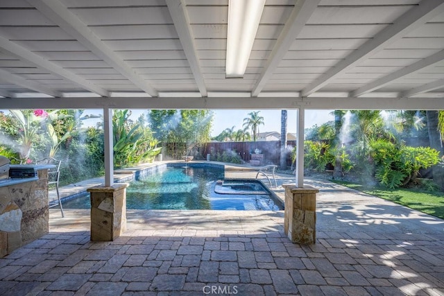 view of swimming pool featuring a jacuzzi, pool water feature, and a patio