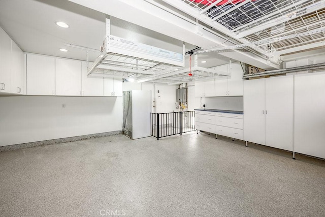 garage with white fridge and water heater